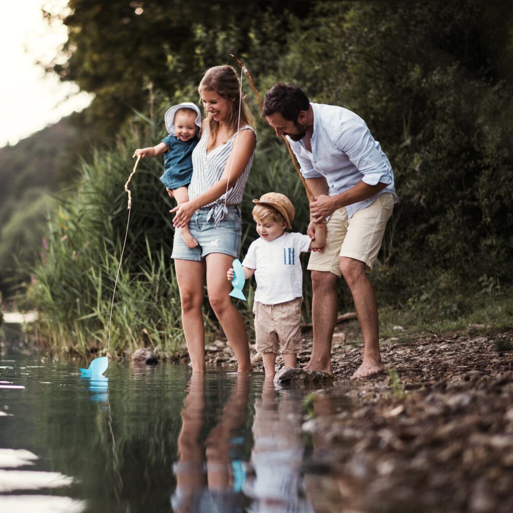 A family spending time outdoors by the water.