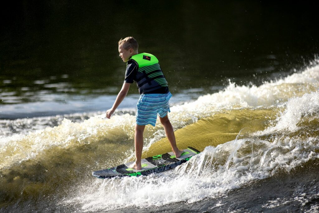 Child wearing a properly fitted youth life vest for wakeboarding