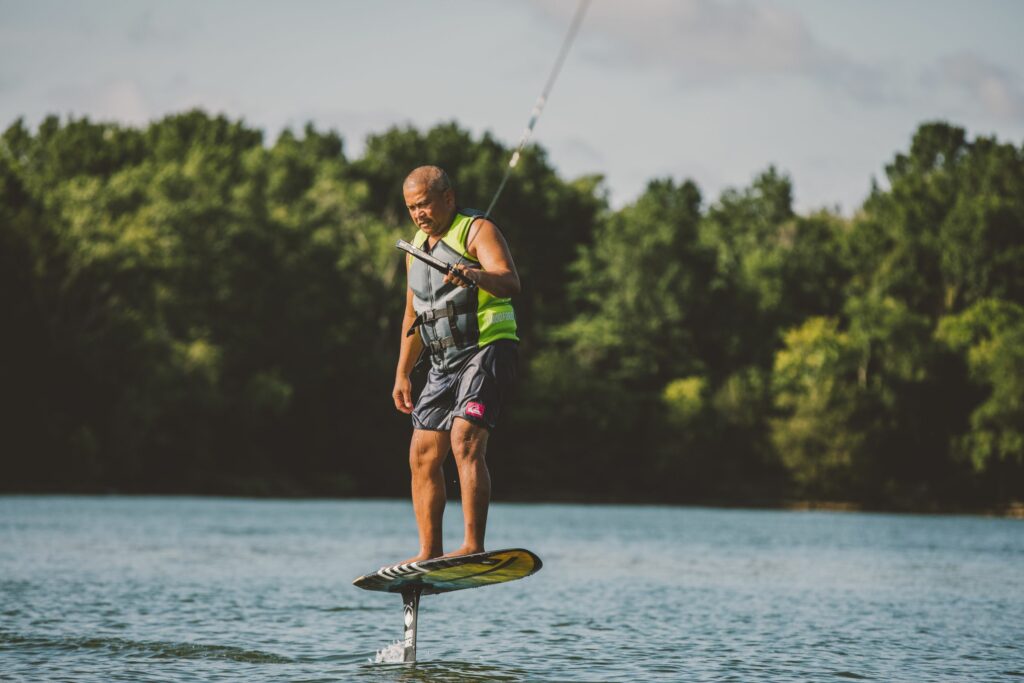 Man perfecting his foot placement on a wake foil board.