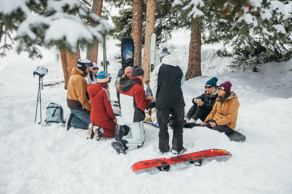 Après-ski snacks and mountain grazing board displayed on a ski under bluebird mountain skies
